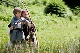 Brother Guilbert teaching young Arn to use a bow